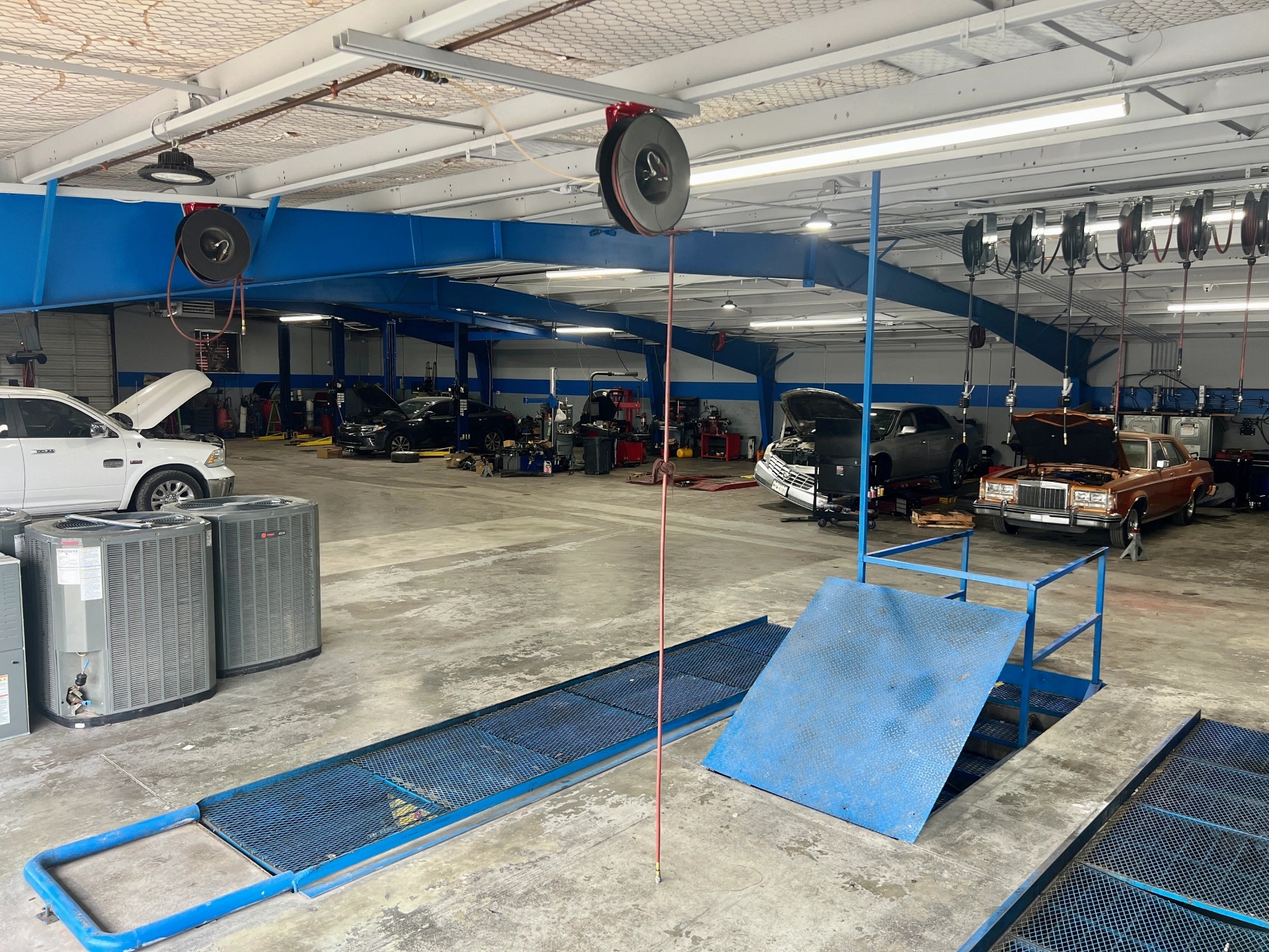 Auto repair service bays with vehicles being serviced at Firestone Buckner mechanic shop in Buckner MO